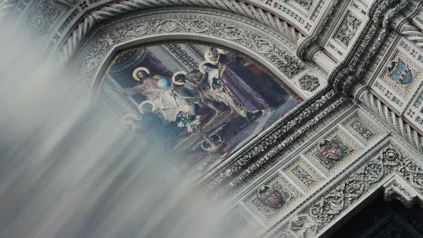 Religious painting and architecture designs on a building wall outdoors during daytime