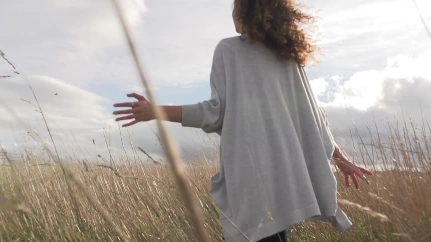 Woman walks through a field