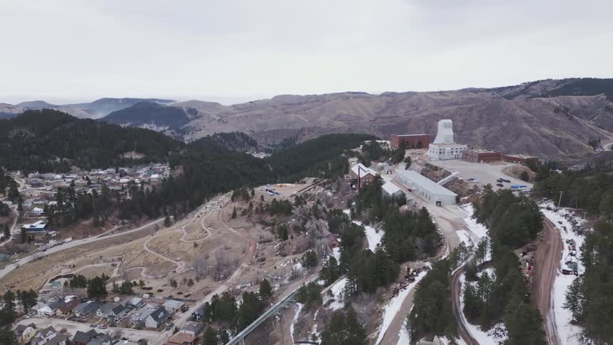 Business buildings stand on a hill overlooking nearby residential neighborhoods on a winter day