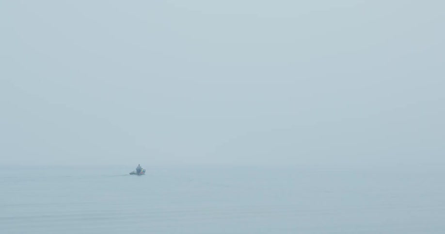Person rides in a small vehicle on an overcast winter day