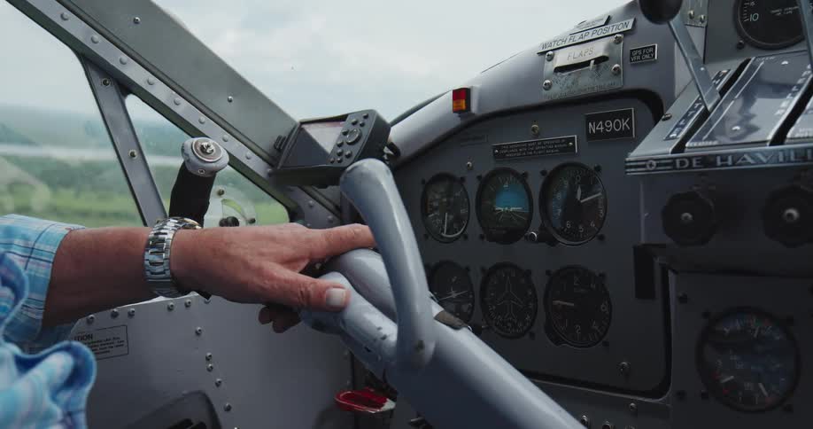 Havilland aircraft control panel operated by person in blue plaid shirt