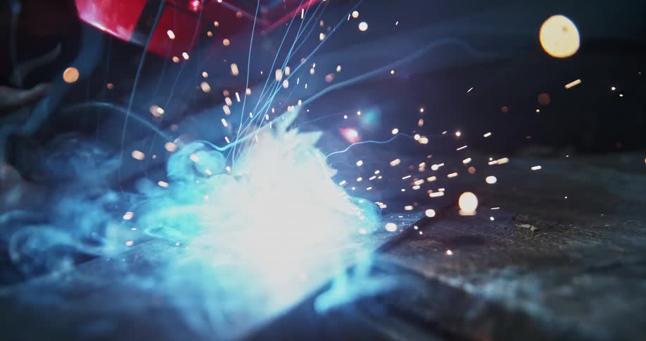 The metalworker is using a torch on sheet metal