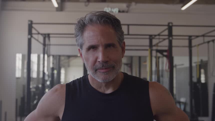 Close up portrait of a middle aged man in a gym during daytime