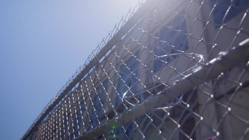 The fence in front of the building has barb wire