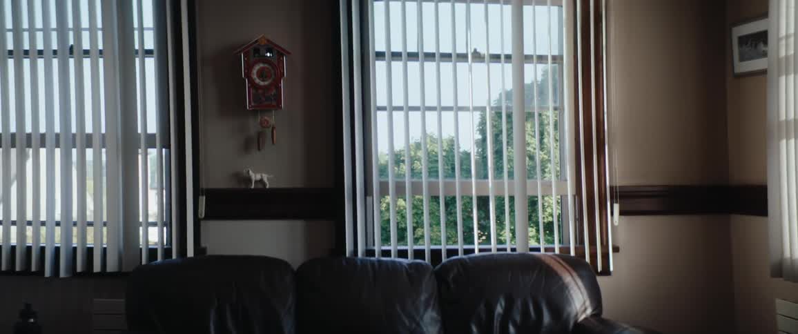 Living room with window showing trees on the outside indoors during day time