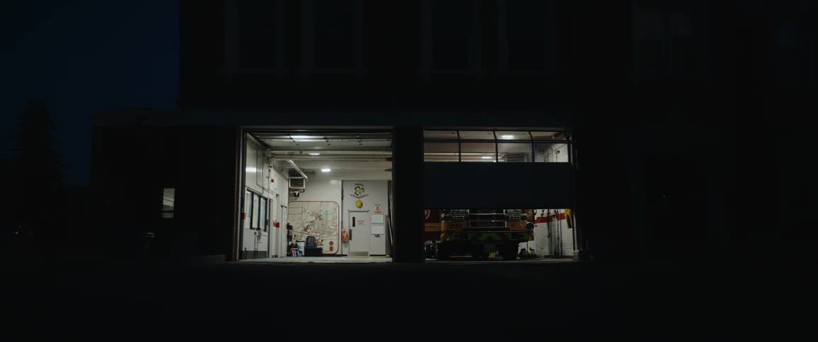 The fireman opens the garage doors to the firehouse