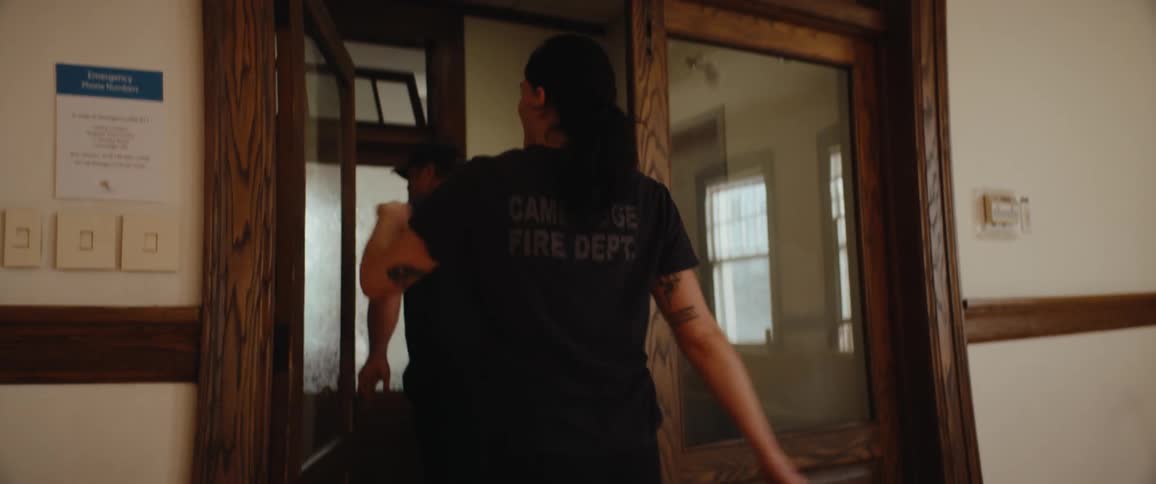 The woman flexes and then leaves the room