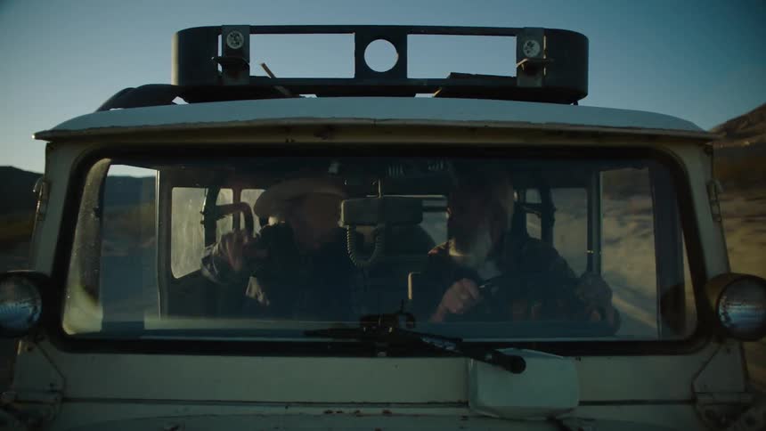 Two people talk while traveling in a truck