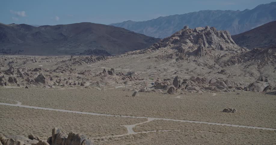 Aerial landscape of an arid landscape with mountains in the background