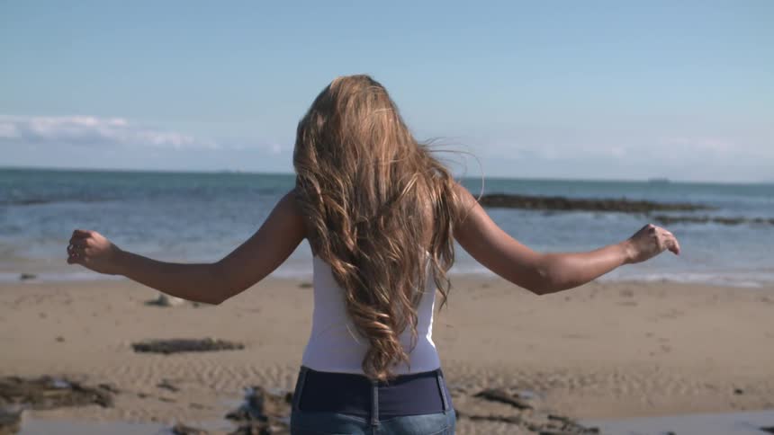 Woman walking on a sandy beach