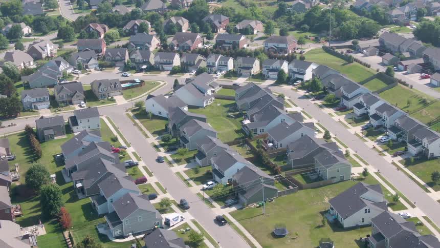 Residential neighborhood with houses arranged along curved streets and wellkept lawns