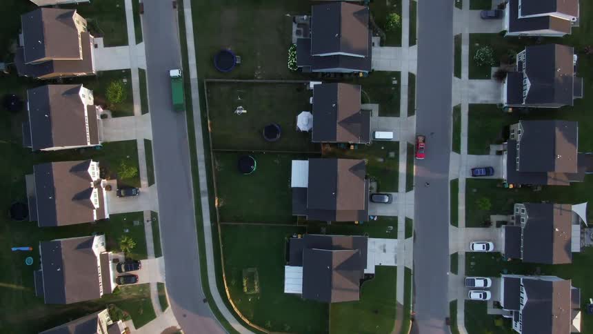 A suburban region with a series of houses and a road path at midday