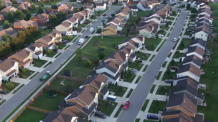 Singlefamily homes arranged along paved streets with wellkept lawns