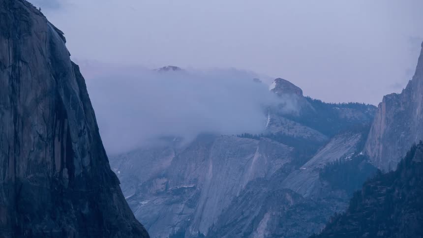 The clouds touch the top of the mountains
