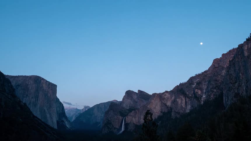 A mountain range with rugged peak terrain at sunset