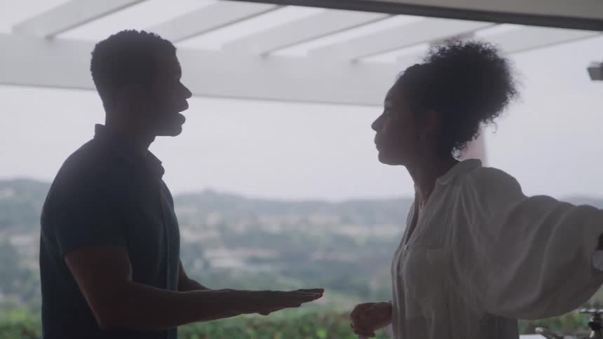 Man and woman argue intensely in a bright modern kitchen
