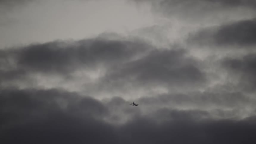 The plane flies into the cloudy sky