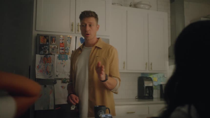 The mother scrolls on her phone as the father talks and walks away
