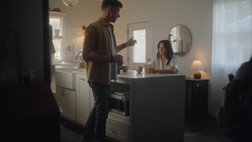 Father prepares to take his kids to school and instructs his wife in the kitchen before leaving in the morning