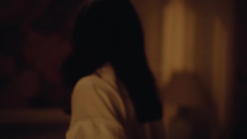 Couple talks in a tense tone in the softly lit kitchen