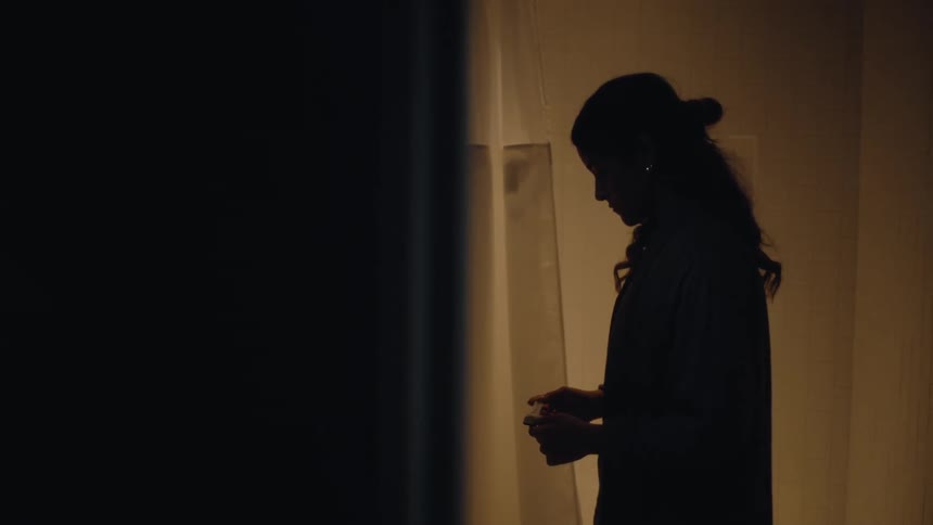 Woman in bathroom holding a pregnancy test