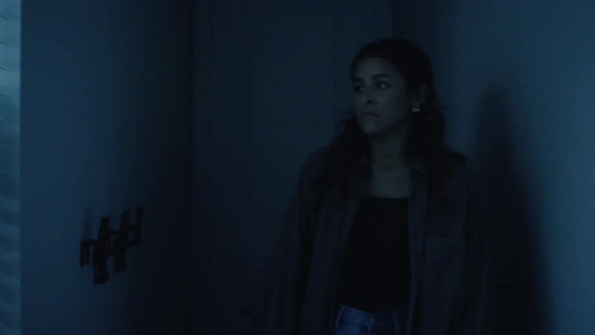 A person walks into a darkened room their silhouette backlit as they open a door into a brightly lit space the sharp contrast in light levels creates a dramatic somewhat mysterious atmosphere of entering or leaving a place