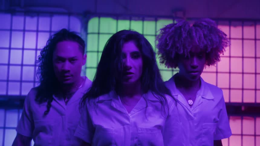 Portrait of three people in a lowlight indoor space