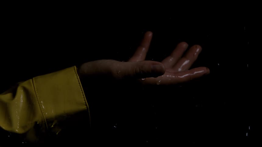 Rain is pouring on the persons hand