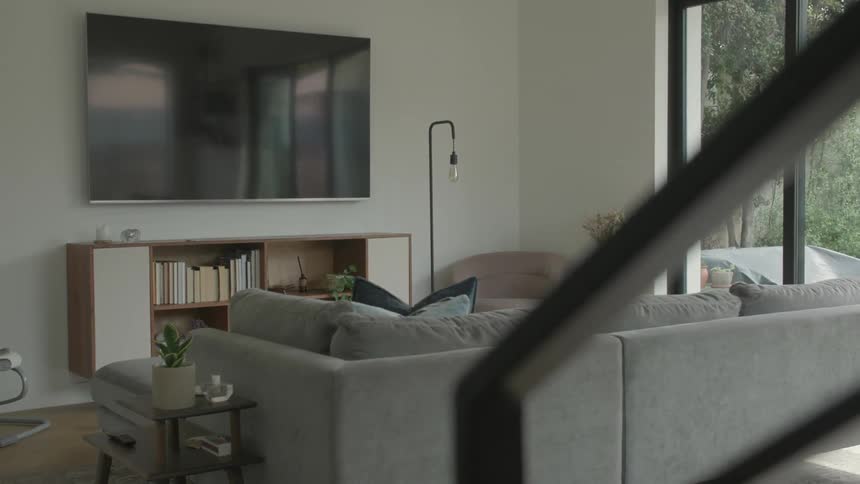 Interior design of a living room with a tv on the wall