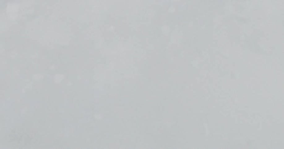 Snowboard glides through fresh snow in motion