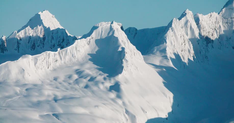 Snowcovered mountains under a clear blue sky
