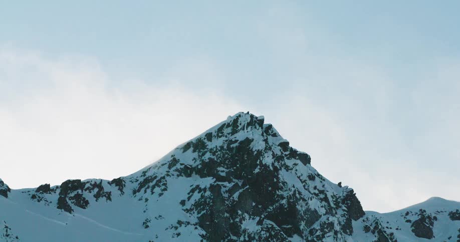 The tall mountain is covered with deep white snow