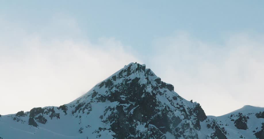 The heavy clouds flow over the mountains