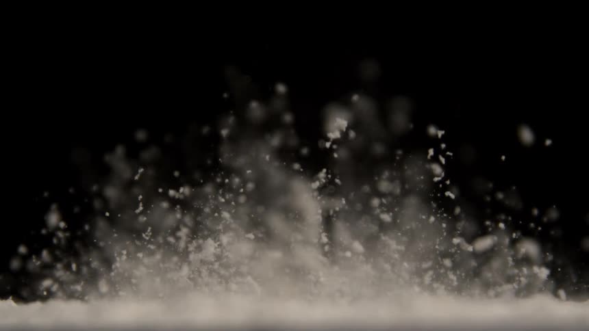 White powder is vibrated on a surface causing it to jump into the air
