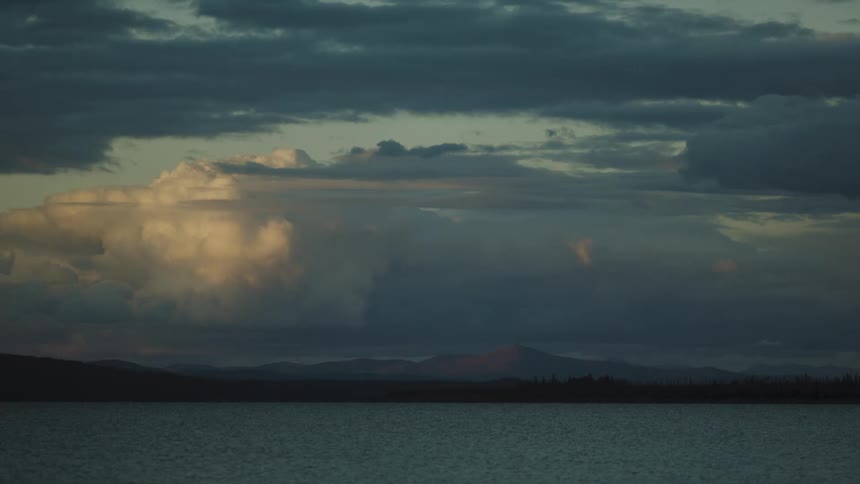 The sun is rising on the large lake