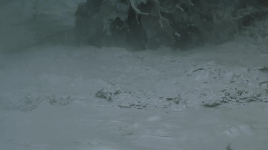 Boiling mud bubbles in a geothermal area covered by steam