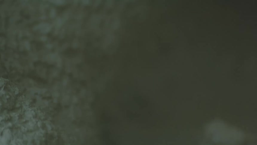 Bubbling surface of a thick grayish liquid