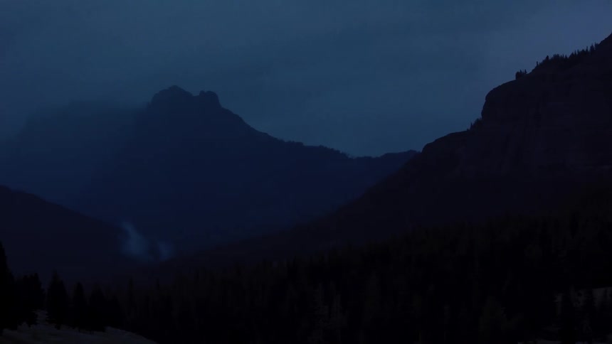 Heavy fog covers the mountains at night