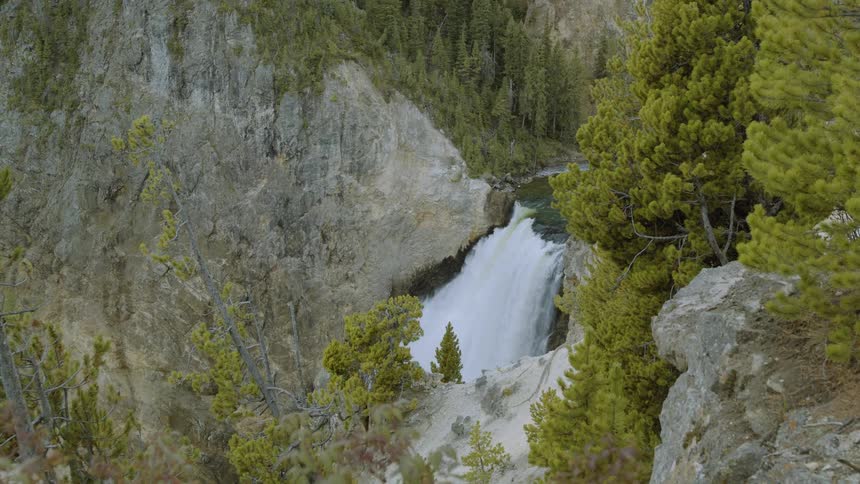 A large waterfall is on the tall mountain