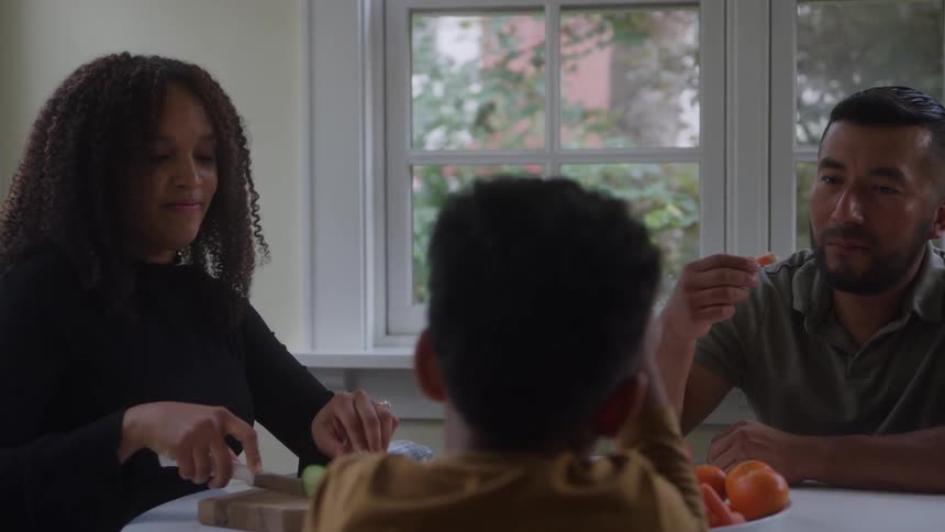 The family eat together at the table