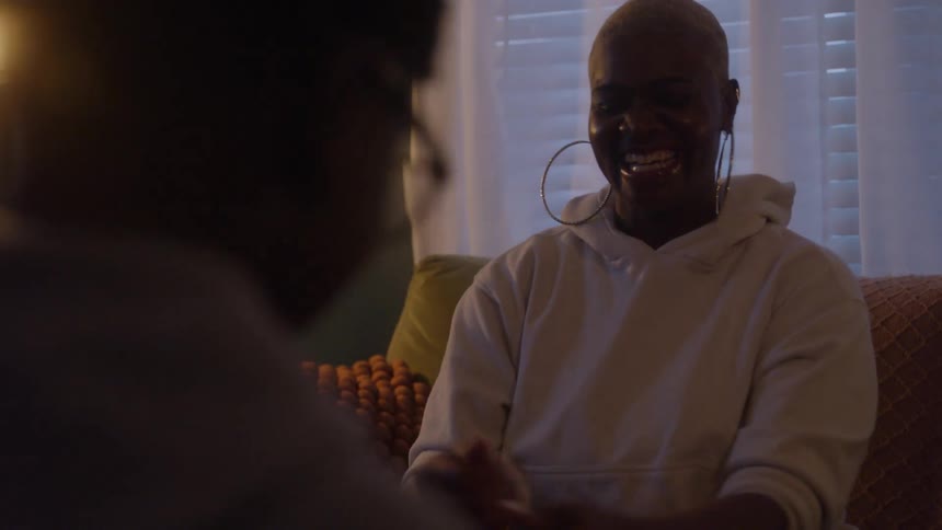 Woman smiling while talking with her son in a cozy setting