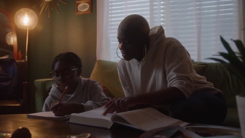 A mother helps her daughter with homework