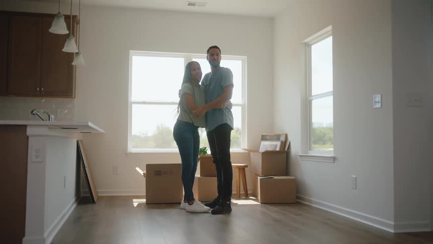 A couple hug in a sunny room