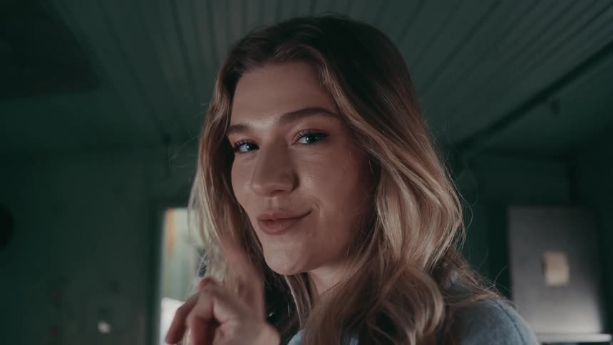 The woman puts her finger up to her lips shushing