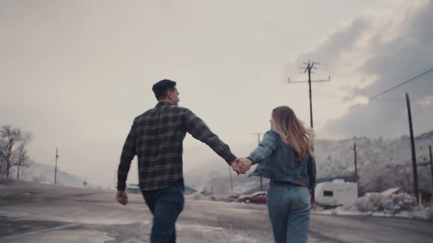 A couple walking and holding hands