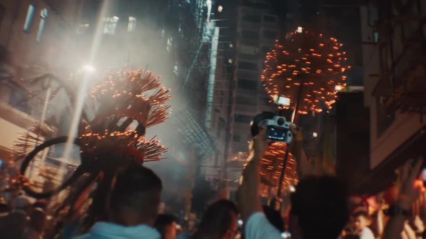 Fire dragon advances through smoke and lights under the crowds gaze