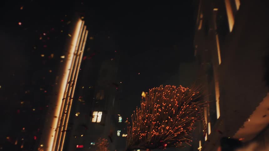 Glowing sparks scatter as the fire dragon is lifted