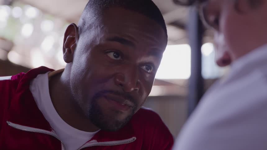 Coach listens intently to the boxer during a conversation in the ring