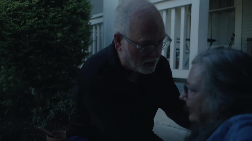 Elderly man rushes to help his wife who has taken ill while gardening