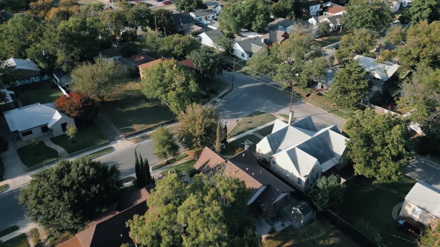 Aerial view of a suburban neighborhood with trees and houses